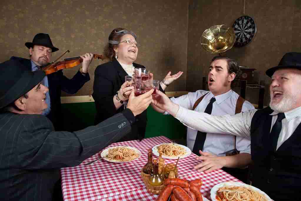 italian family eating and toasting together