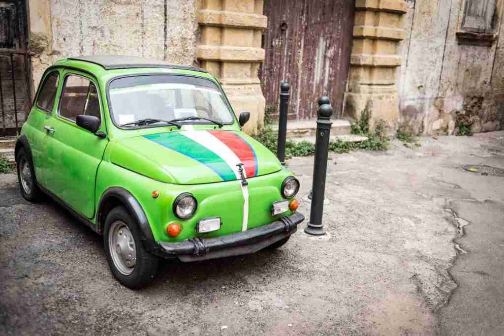 green fiat 500 italian car vintage with italian flag in rome things you don't know about italy