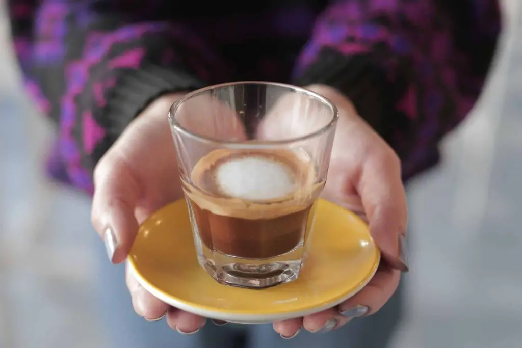 hand offering a cup of italian espresso
