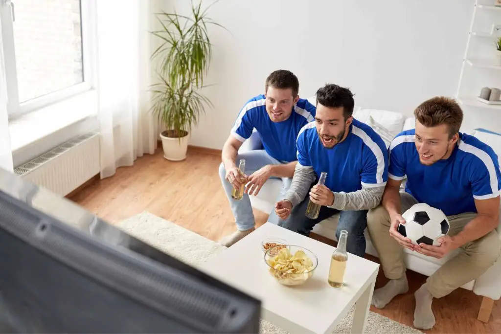 italian guys watching football at tv