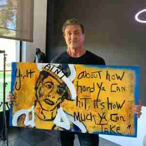 sylvester stallone holds his paiting Sylvester Stallone Italian roots.