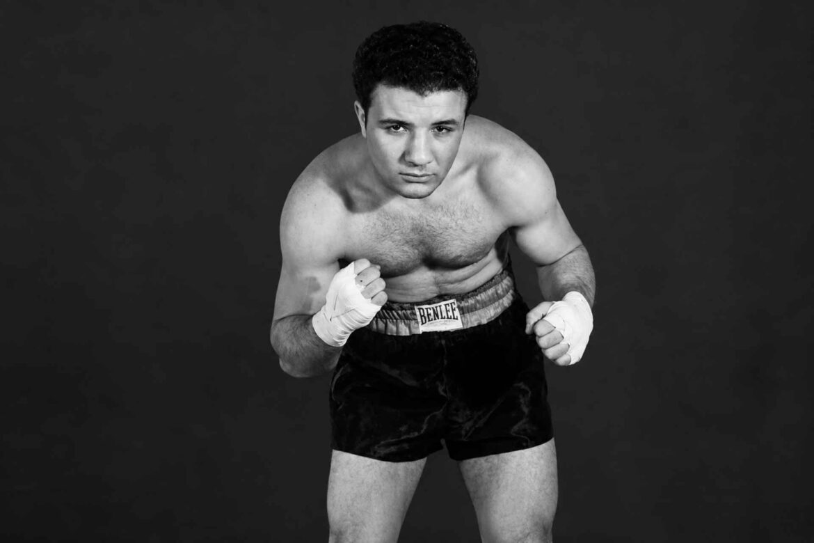 Jake LaMotta posing in a boxing stance with wrapped hands during his professional boxing career